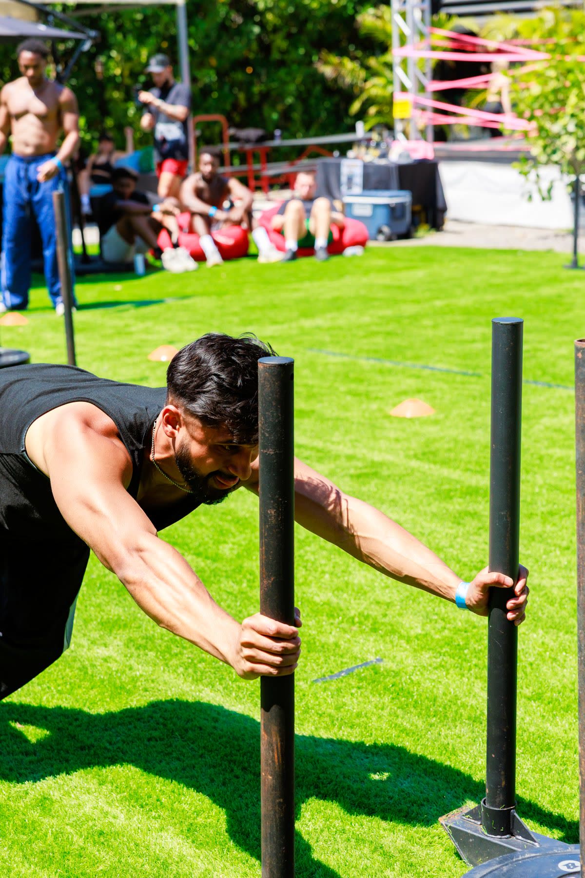 Athlete pushing a sled down the race lane